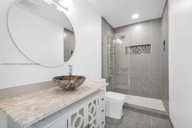 a bathroom with a toilet a sink and a mirror