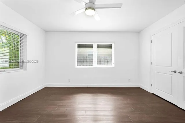 an empty room with wooden floor