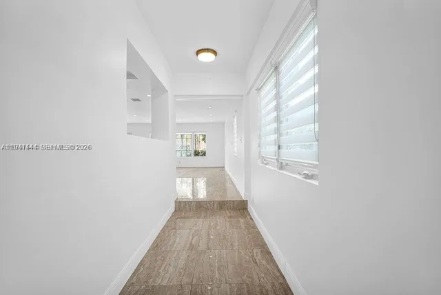 a view of a storage and utility room with washer and dryer