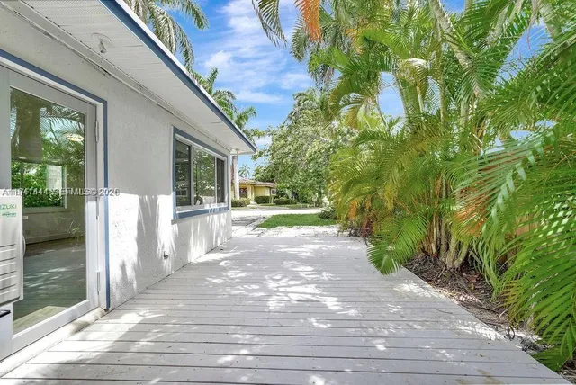a view of a house with a yard and plants