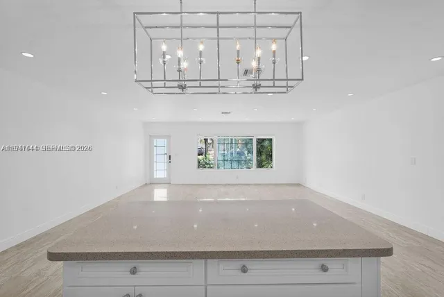 a kitchen with stainless steel appliances granite countertop a refrigerator sink and cabinets