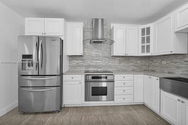 a kitchen with white cabinets and white appliances