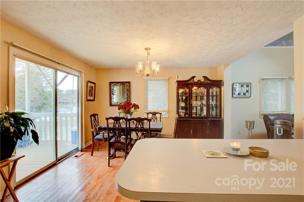 262 Spring Run Road Mooresville, NC 28117 - Photo 15 of 42 a view of a dining room with furniture window and wooden floor