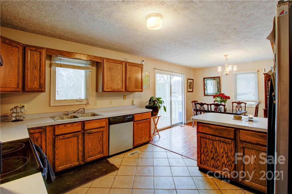 262 Spring Run Road Mooresville, NC 28117 - Photo 18 of 42 a kitchen with stainless steel appliances a sink stove and cabinets