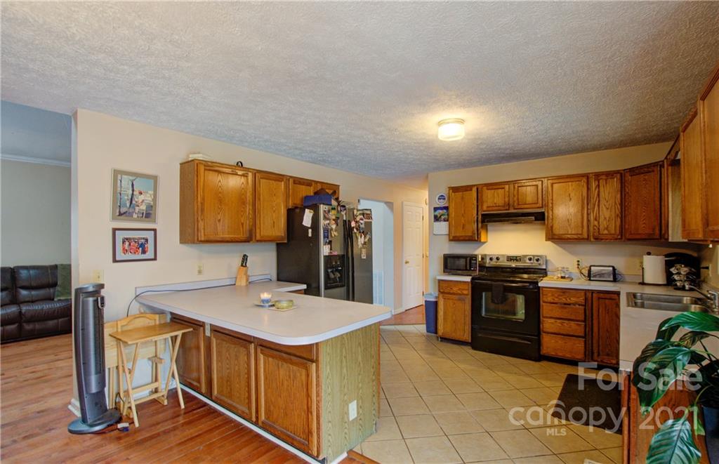 262 Spring Run Road Mooresville, NC 28117 - Photo 20 of 42 a kitchen with stainless steel appliances granite countertop a sink stove and refrigerator
