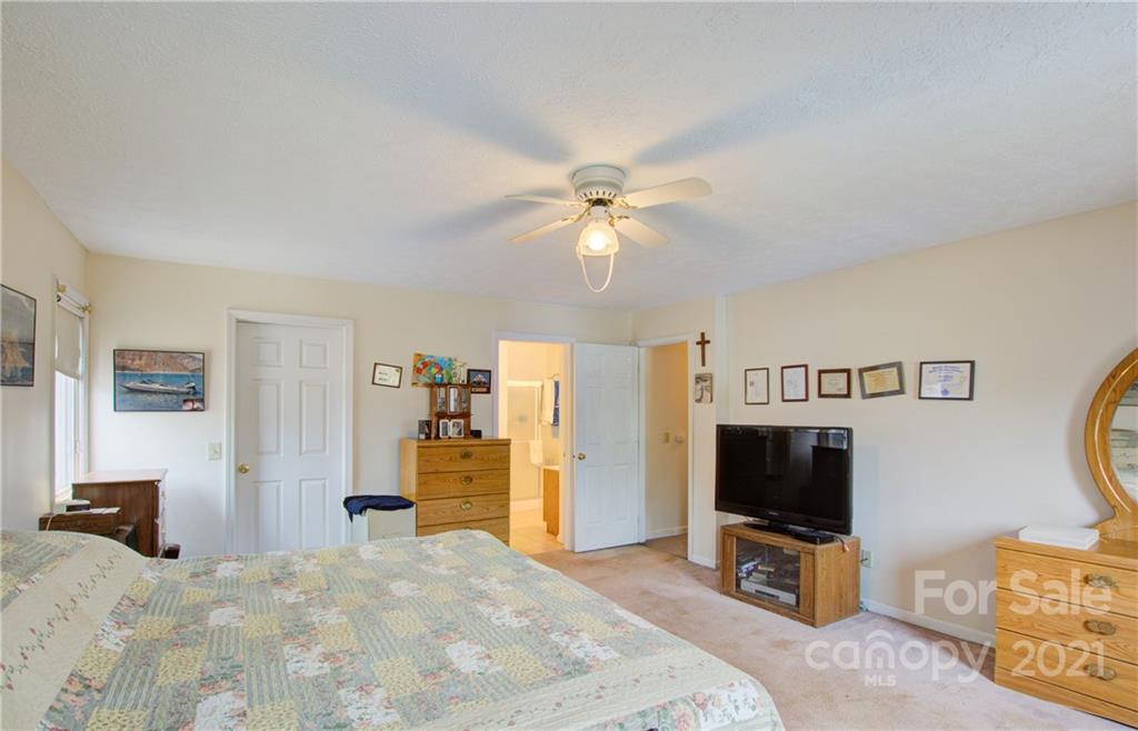 262 Spring Run Road Mooresville, NC 28117 - Photo 27 of 42 a bedroom with a bed and a flat tv screen on wall