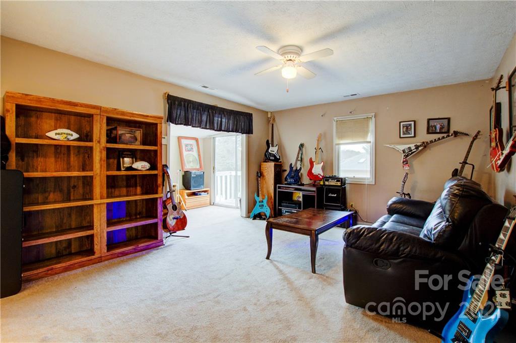 262 Spring Run Road Mooresville, NC 28117 - Photo 32 of 42 a living room with furniture a lamp and a window