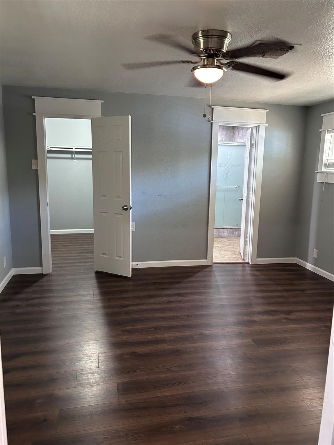 1212 Alamo Street Rosenberg, TX 77471 - Photo 11 of 34 a view of a livingroom with wooden floor a ceiling fan and kitchen space
