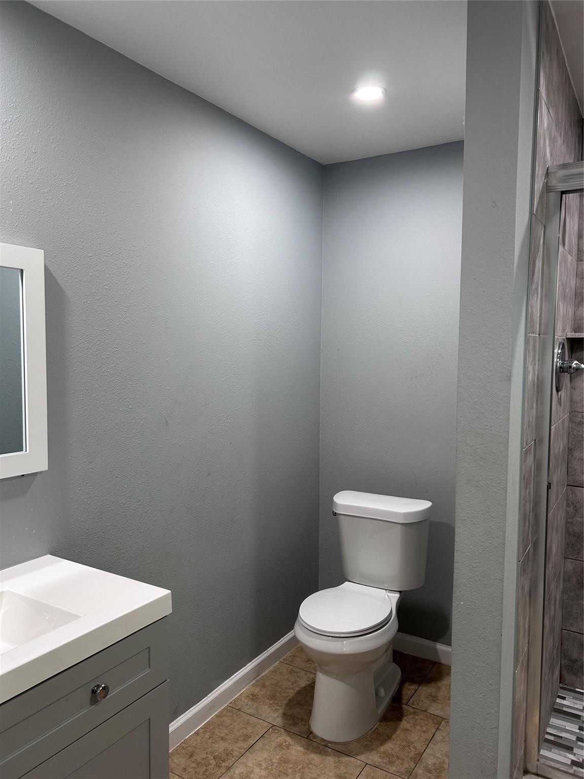 1212 Alamo Street Rosenberg, TX 77471 - Photo 12 of 34 a bathroom with a toilet a sink and vanity