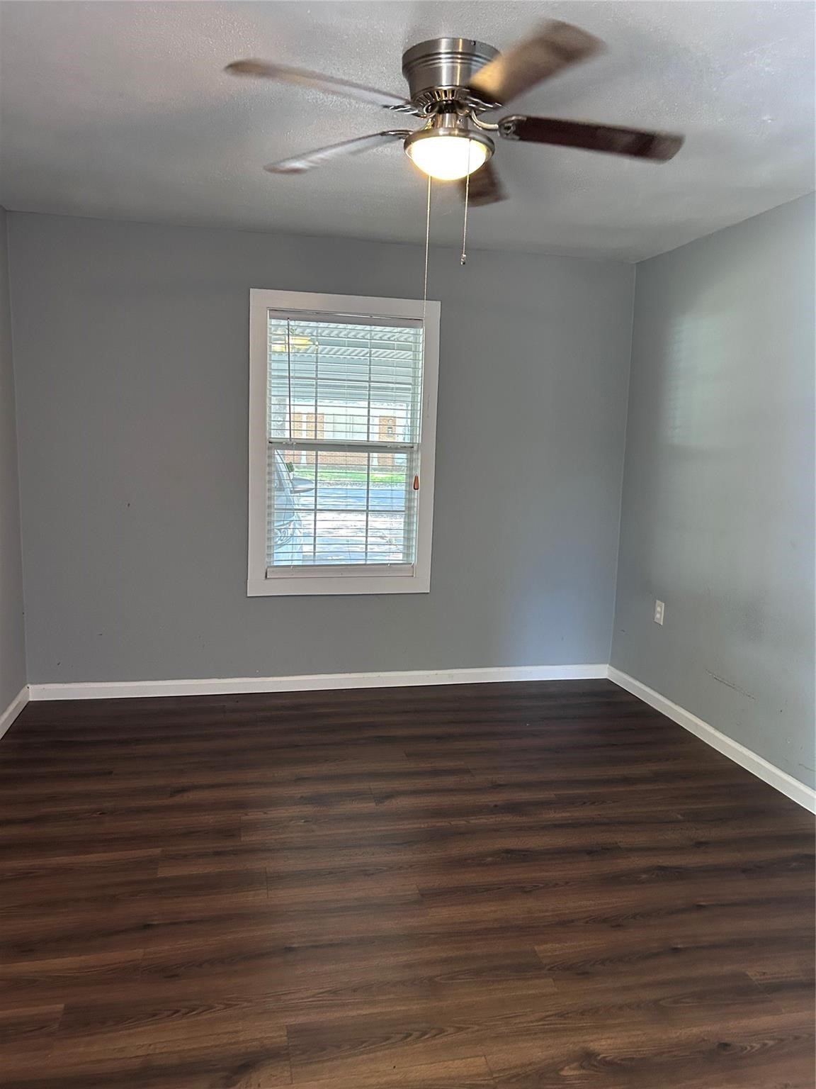 1212 Alamo Street Rosenberg, TX 77471 - Photo 17 of 34 a view of an empty room with wooden floor cabinets and a window