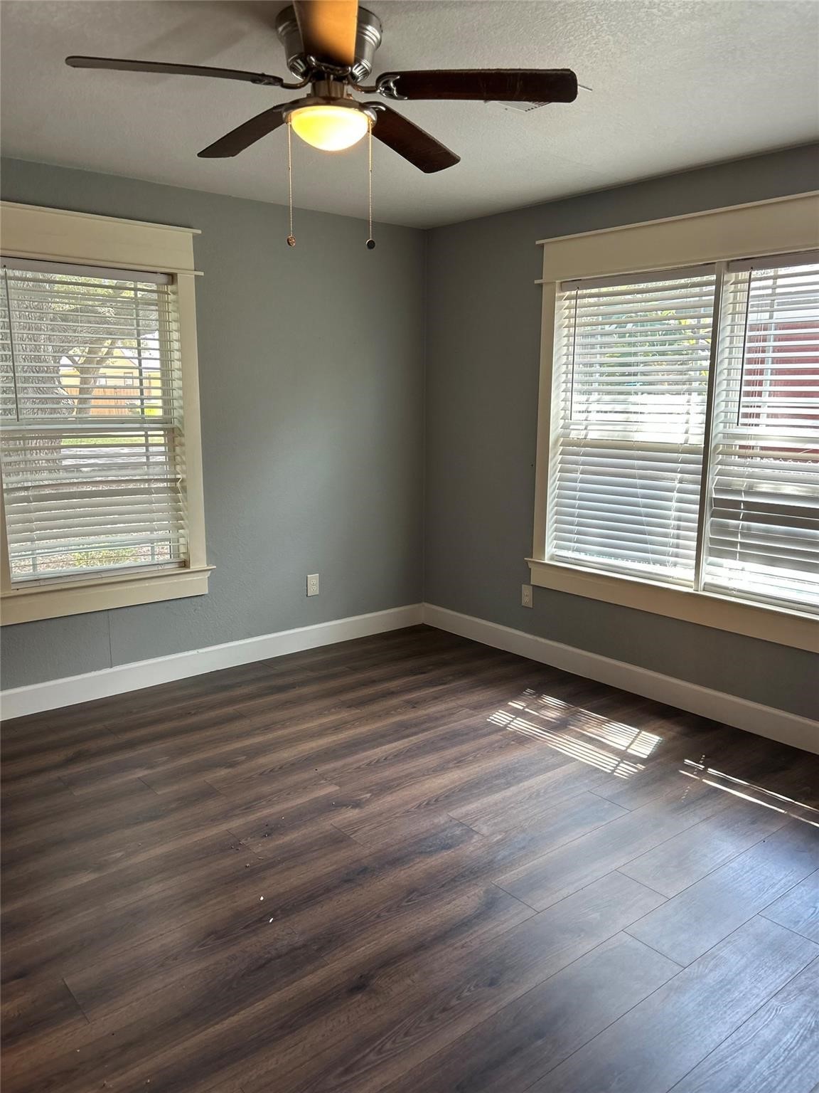 1212 Alamo Street Rosenberg, TX 77471 - Photo 26 of 34 an empty room with wooden floor fan and windows