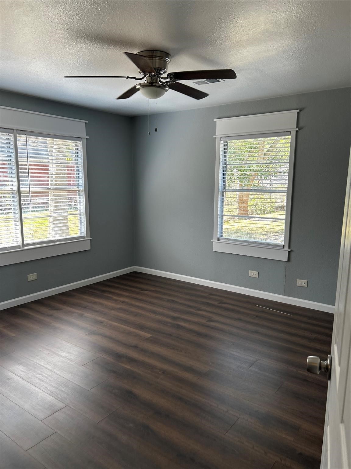 1212 Alamo Street Rosenberg, TX 77471 - Photo 27 of 34 a view of an empty room with wooden floor and a window