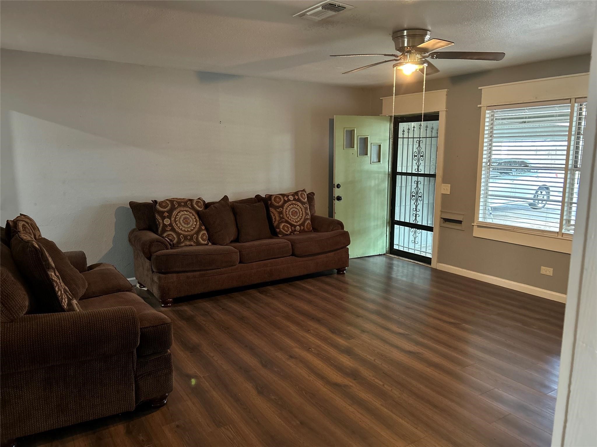 1212 Alamo Street Rosenberg, TX 77471 - Photo 5 of 34 a living room with furniture and a wooden floor