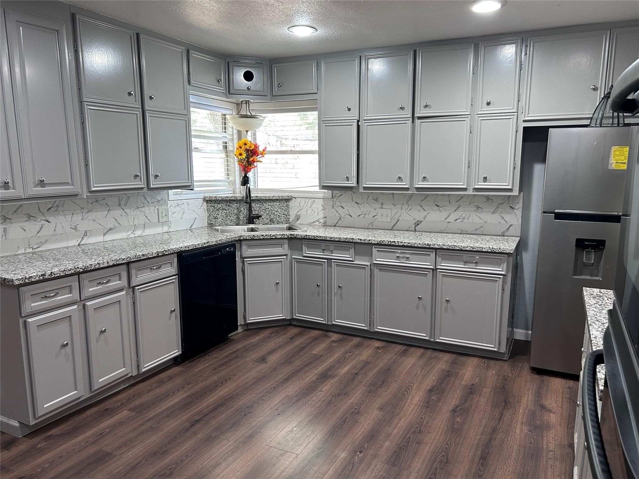 1212 Alamo Street Rosenberg, TX 77471 - Photo 6 of 34 a kitchen with a sink window and cabinets