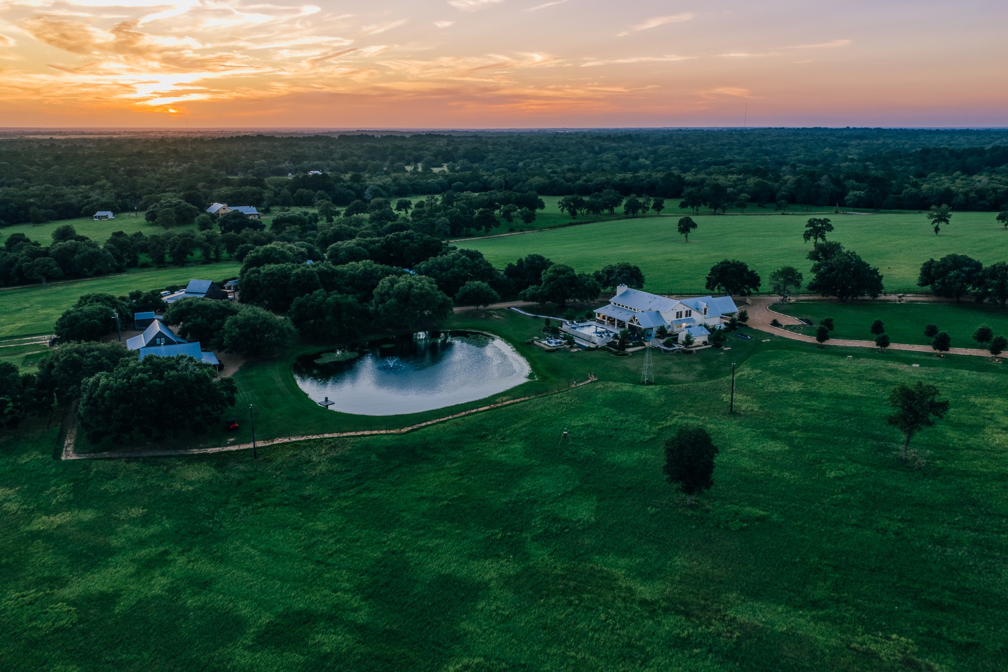 1034 Hilbun Road New Ulm, TX 78950 - Photo 48 of 49 An exceptional legacy property showcasing panoramic views, magnificent oak canopies, sparkling lakes, luxury residences, hunting opportunities, a private shooting range, and unforgettable Texas sunsets.