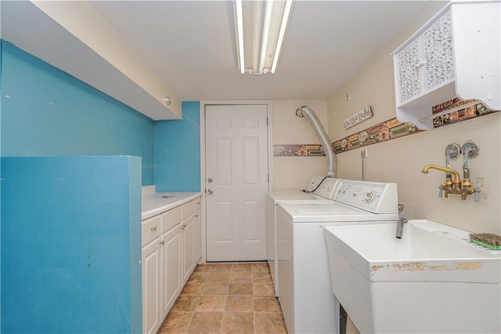 464 73rd Street Brooklyn, NY 11209 - Photo 27 of 37 a utility room with cabinets washer and dryer