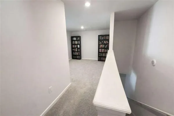 a bedroom with a bed and a lamp on table