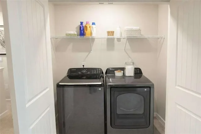 a white toilet sitting next to a white sink and vanity