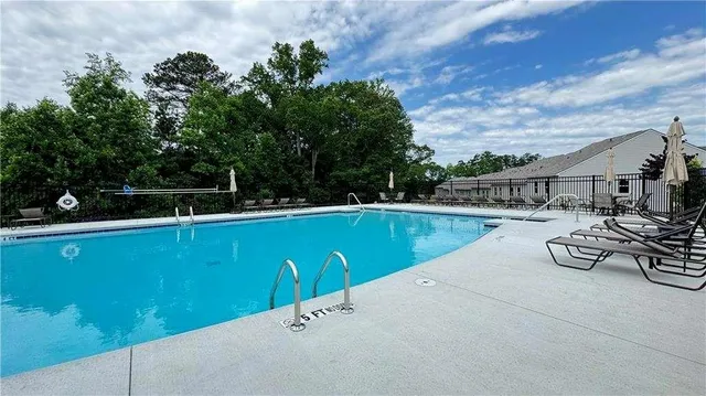 a view of a house with swimming pool and sitting area