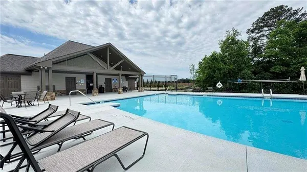 a view of swimming pool with chairs