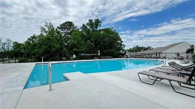 a view of a swimming pool with a yard