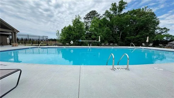a view of a garden with flowers and bench