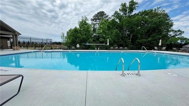 a view of a garden with flowers and bench