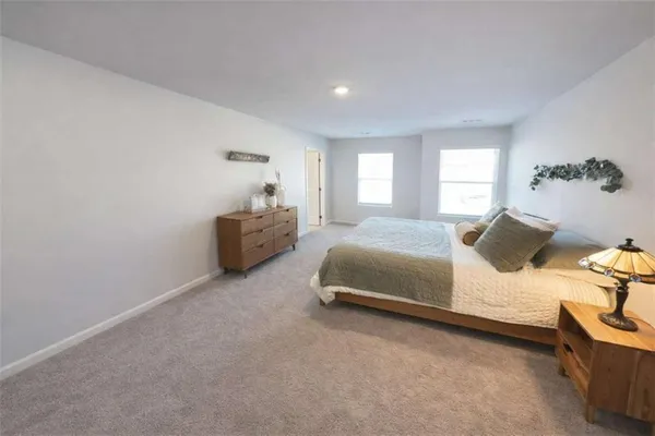 a bedroom with a bed and window