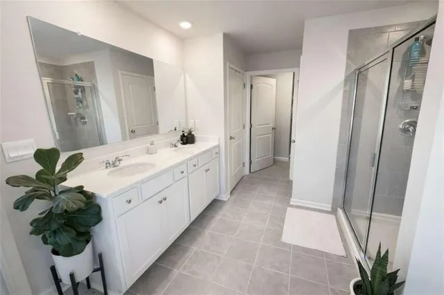 a spacious bathroom with a double vanity sink and a mirror