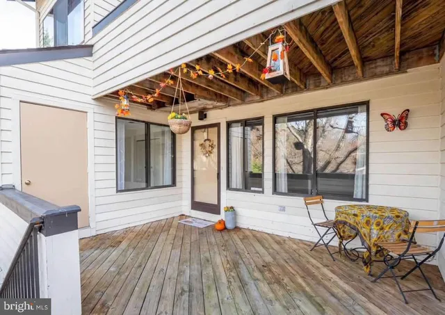 a view of a patio with table and chairs and wooden floor