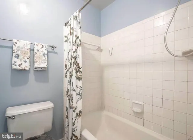 a bathroom with a shower a toilet and a shower