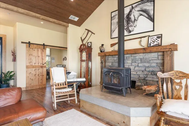 a bedroom with a bed and glass walk in closet