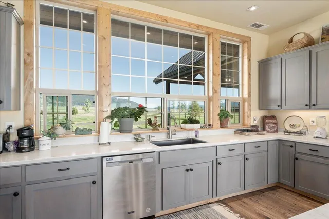 a bathroom with a granite countertop toilet a sink and a mirror