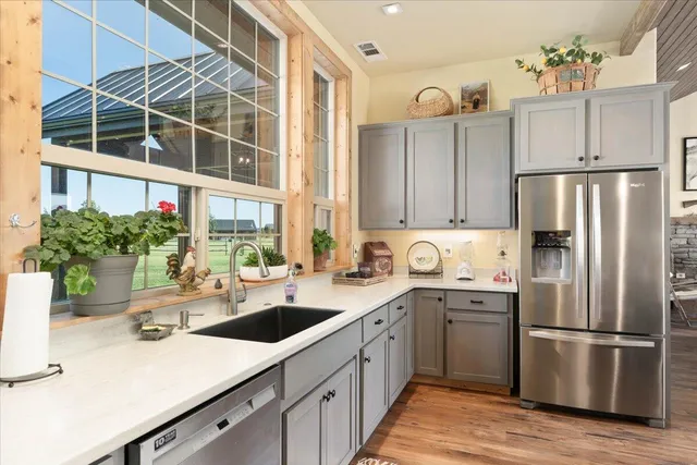 a view of a hallway with a couch and a stove top oven