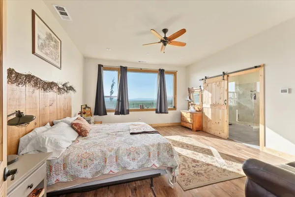 a bedroom with a large bed and a window