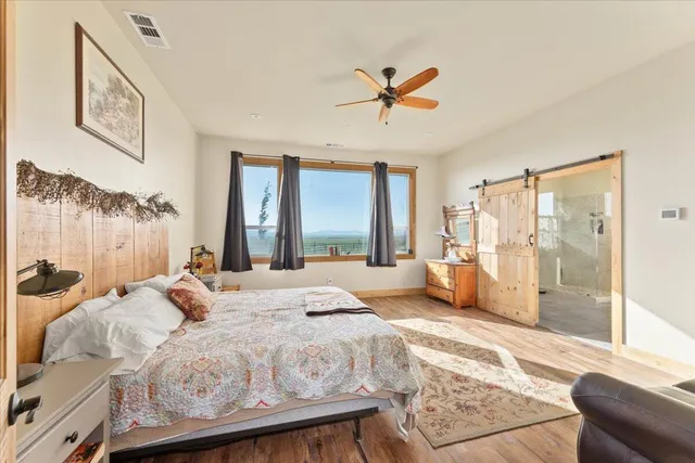 a bedroom with a large bed and a window