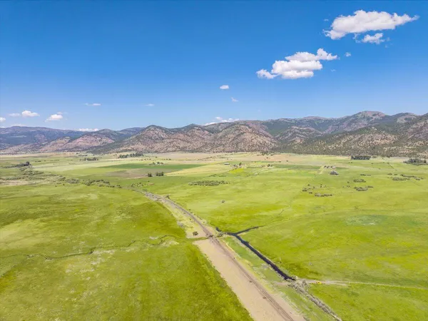 a view of a house with swimming pool and a yard