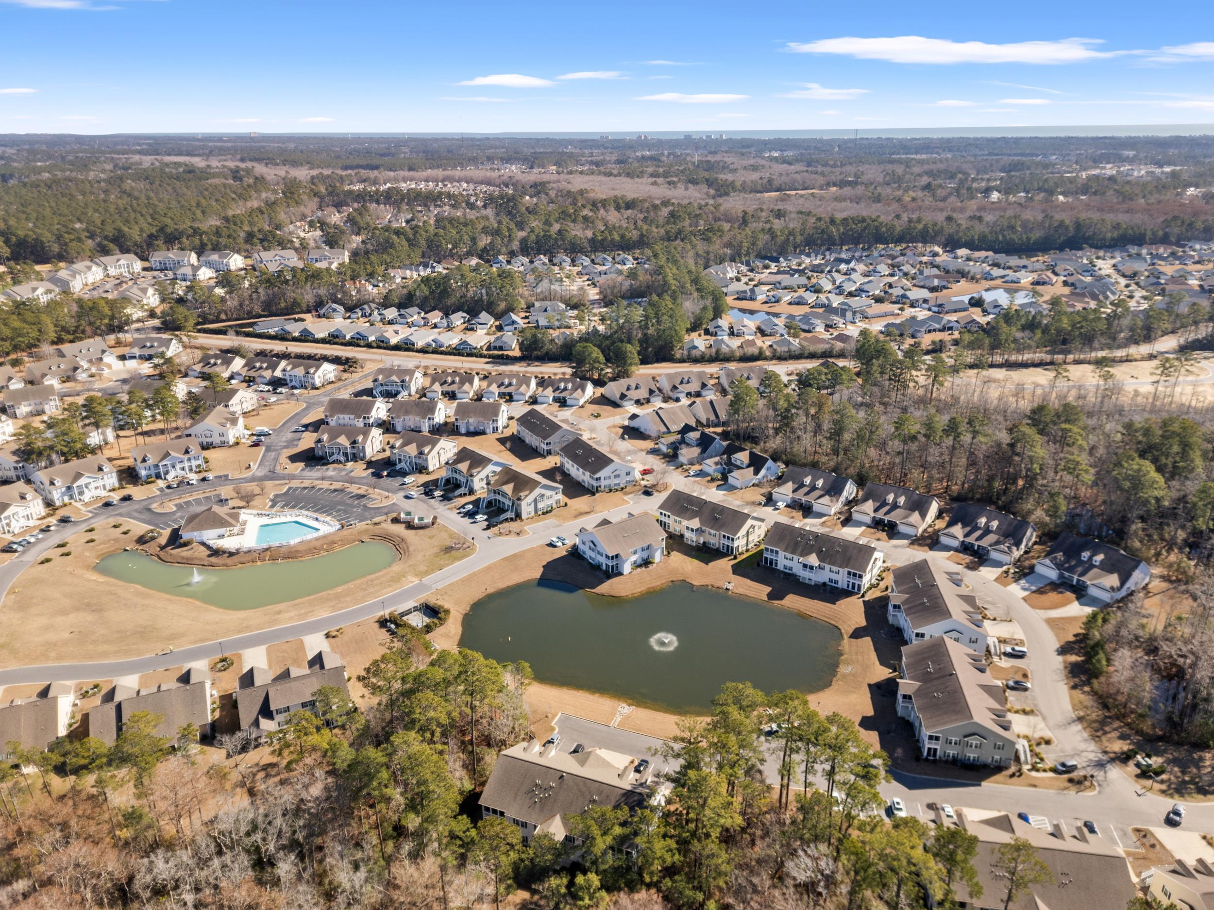 900 Jackline Place, Unit 202 Murrells Inlet, SC 29576 - Photo 10 of 39 Aerial view of property and surrounding area featuring nearby suburban area and a nearby body of water