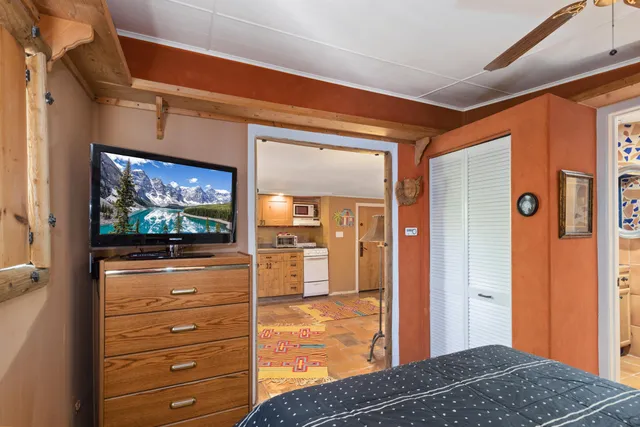 a bedroom with a bed and a flat screen tv