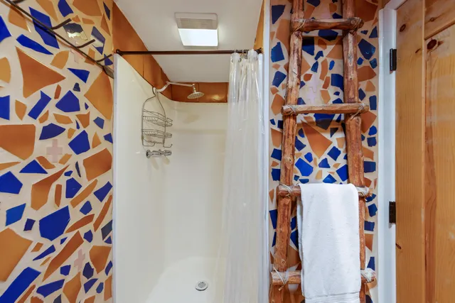 a bathroom with a shower and a curtain