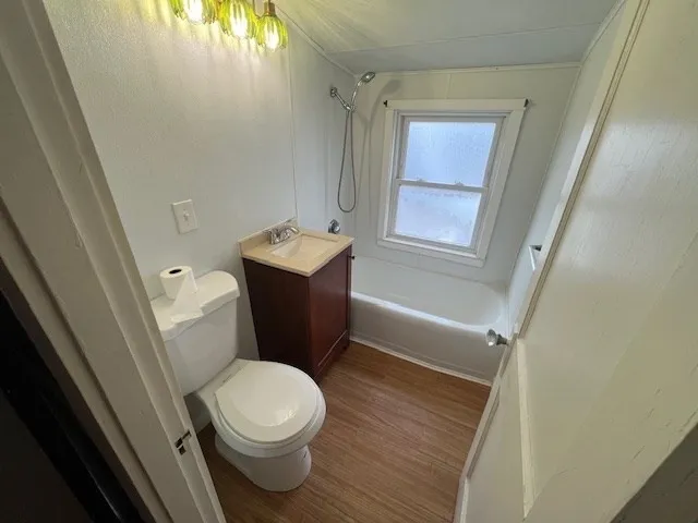 a white toilet sitting next to a bathroom sink