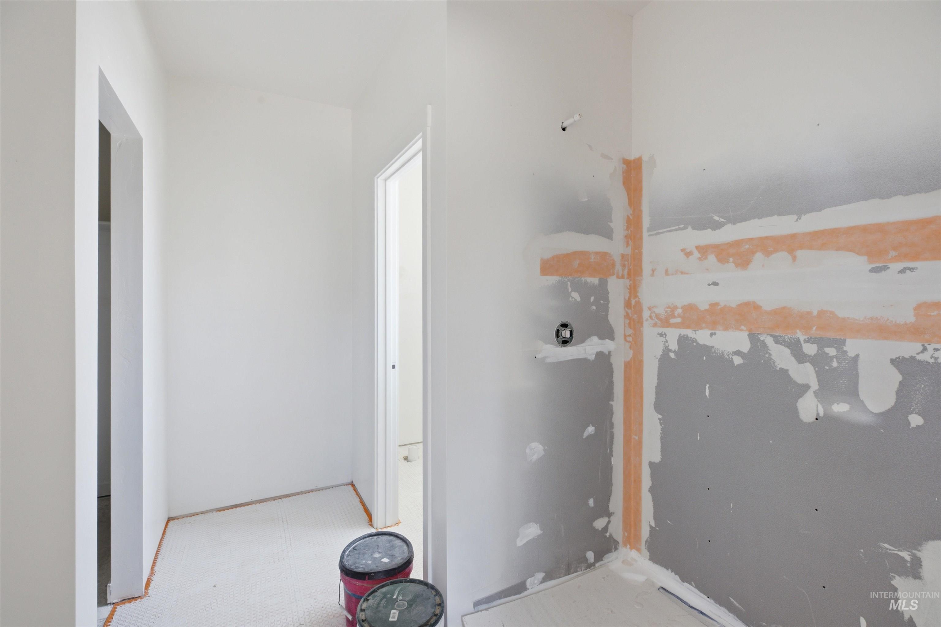 2812 Cyprus Court Moscow, ID 83843 - Photo 11 of 22 Bright interior space featuring a window, modern five-panel interior doors, crisp white walls, and light-toned carpet