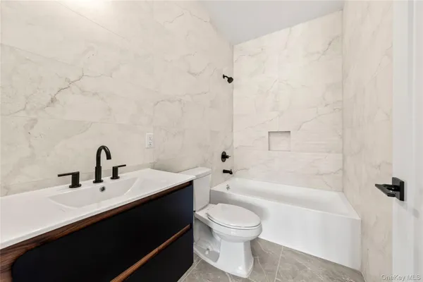 a bathroom with a sink a toilet and bathtub