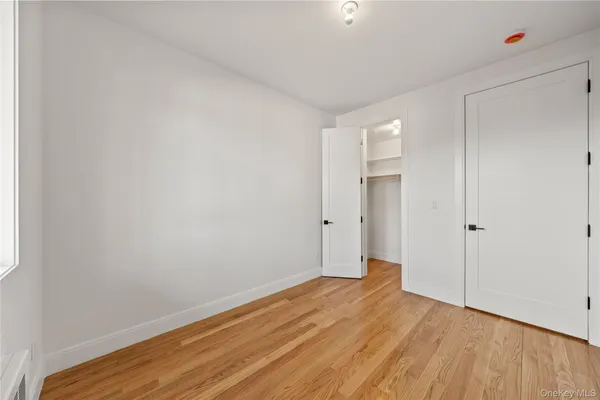 a view of a room with wooden floor and white walls