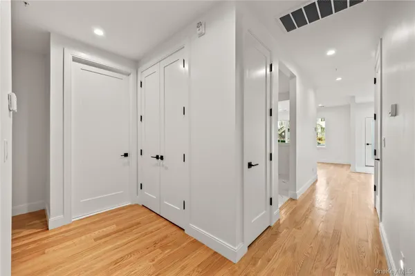 a view of a hallway with wooden floor