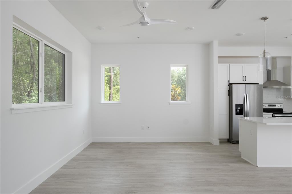 2601 Southwest Williston Road, Unit 9 Gainesville, FL 32608 - Photo 11 of 35 a view of a kitchen with a stove cabinets and a wooden floor