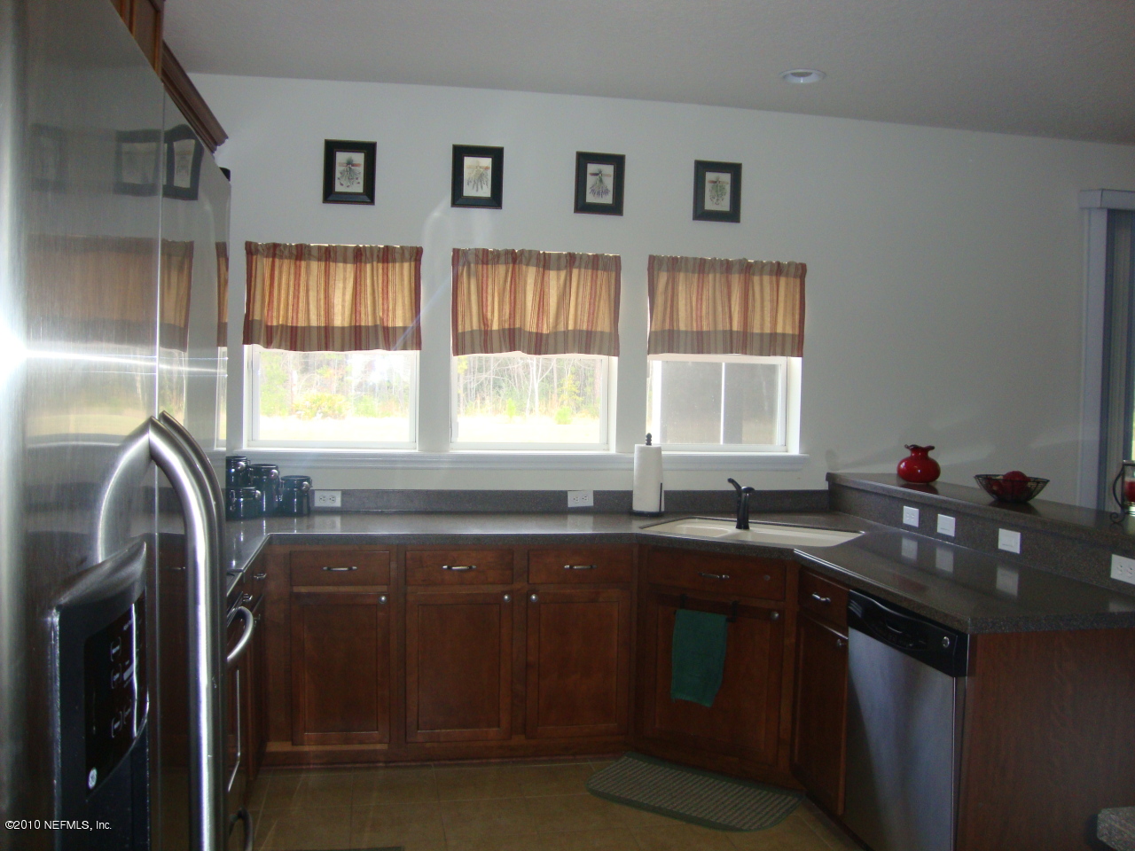 9129 Raptor Drive Jacksonville, FL 32221 - Photo 3 of 32 a kitchen with granite countertop a sink and a window