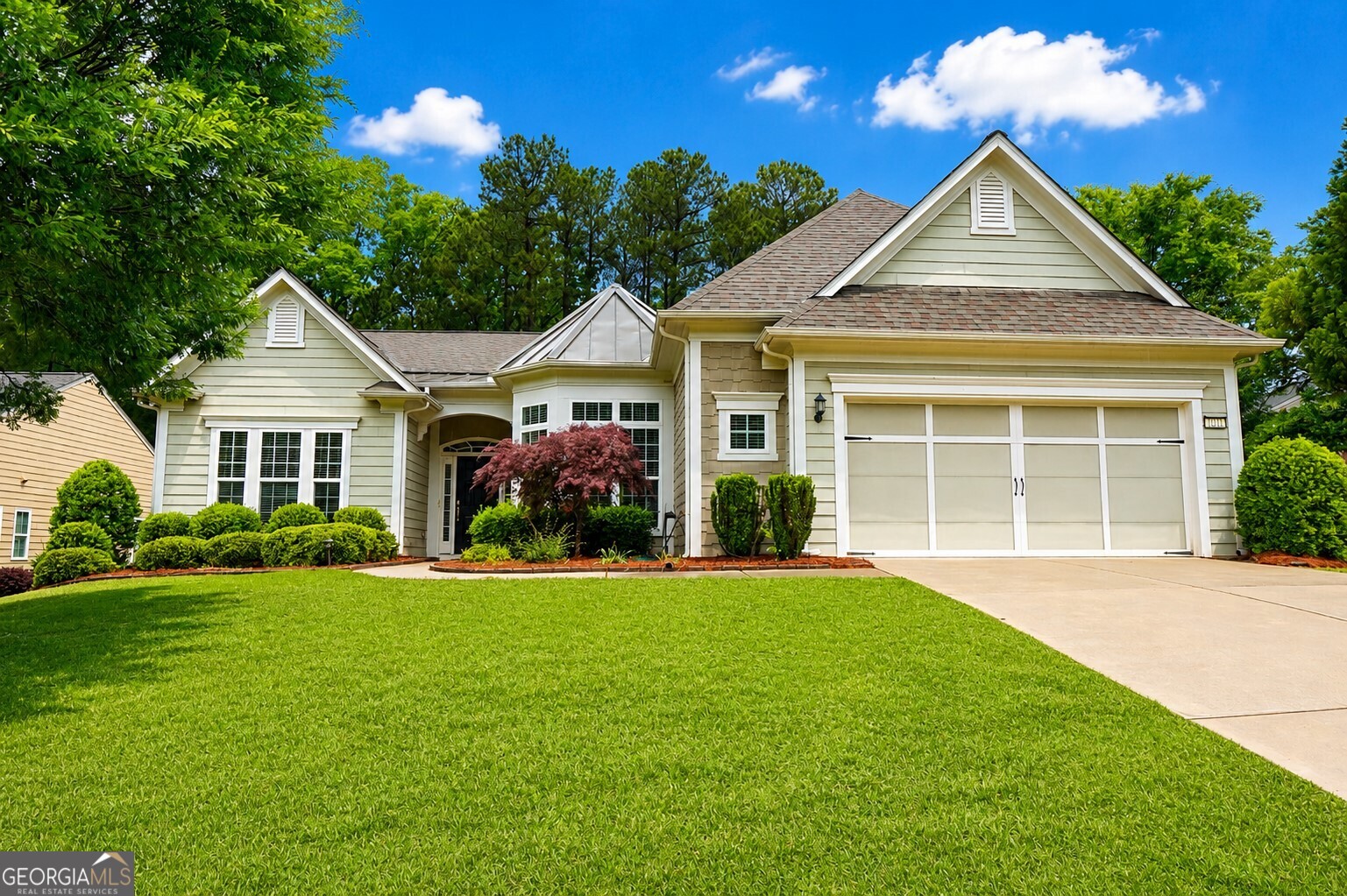 a front view of a house with a yard and garage
