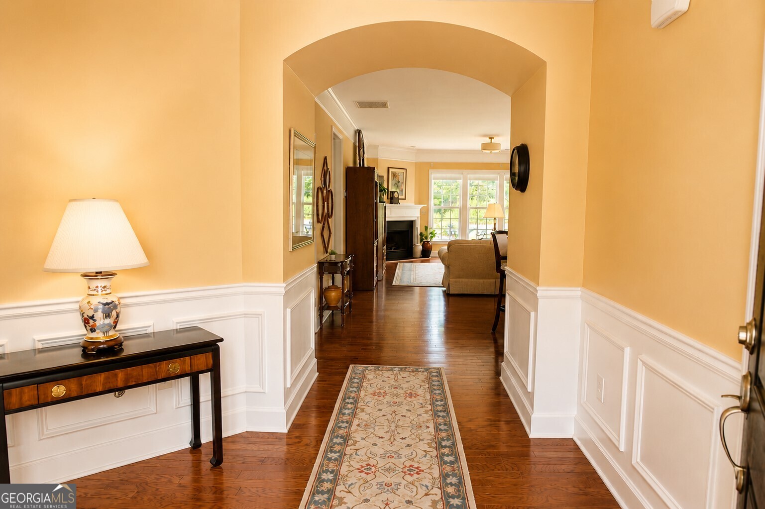 1211 Water Front Road Greensboro, GA 30642 - Photo 4 of 40 a hallway with a couch and wooden floor