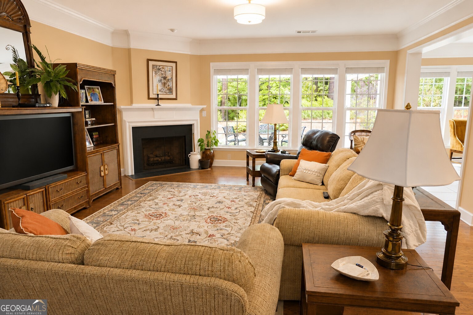 1211 Water Front Road Greensboro, GA 30642 - Photo 5 of 40 a living room with furniture a fireplace and a flat screen tv